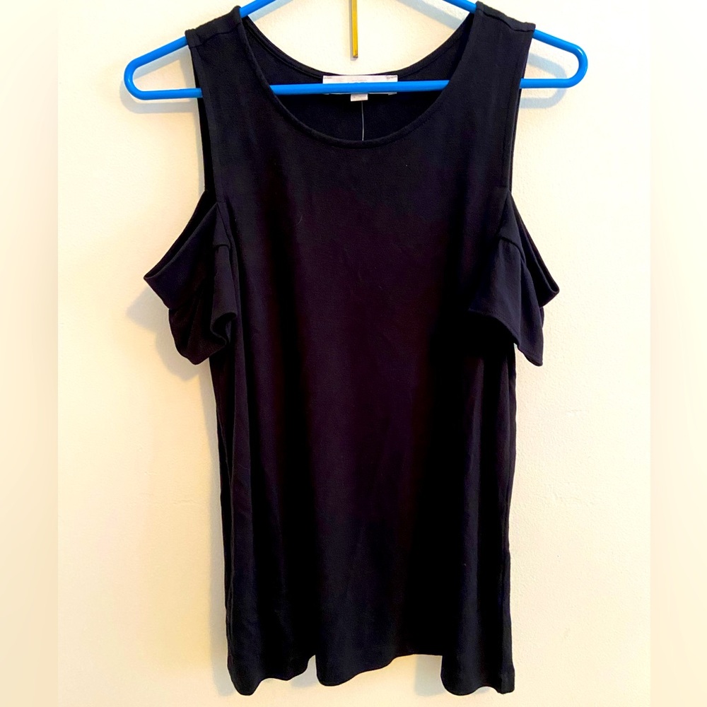 Black off the shoulder, loose fitting shirt.